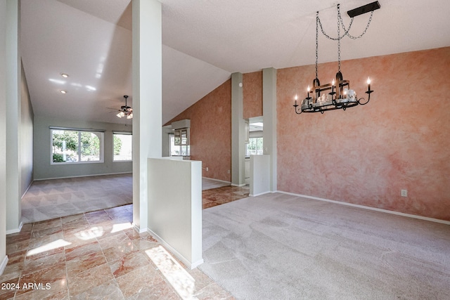 interior space with ceiling fan with notable chandelier and high vaulted ceiling