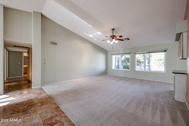 unfurnished living room with carpet flooring, ceiling fan, high vaulted ceiling, and a textured ceiling