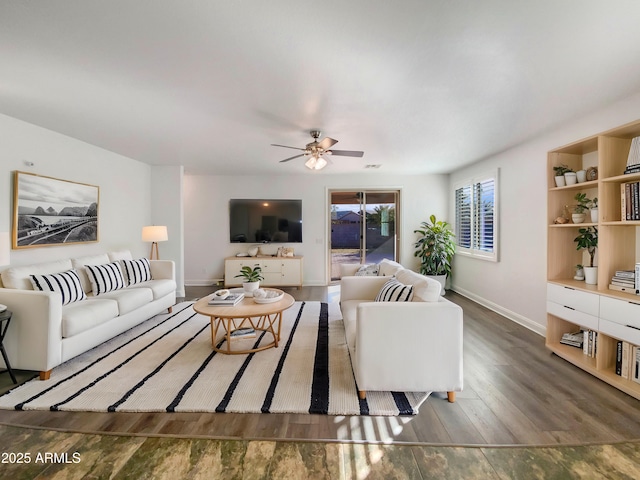 living room with dark wood-type flooring and ceiling fan