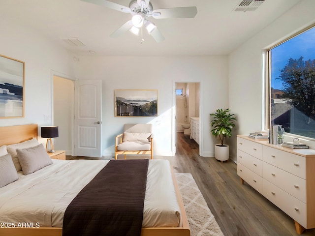 bedroom featuring hardwood / wood-style flooring, connected bathroom, and ceiling fan