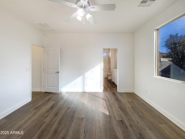 unfurnished bedroom featuring dark wood-type flooring, connected bathroom, and ceiling fan