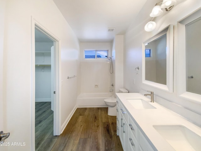 full bathroom featuring  shower combination, hardwood / wood-style flooring, toilet, and vanity