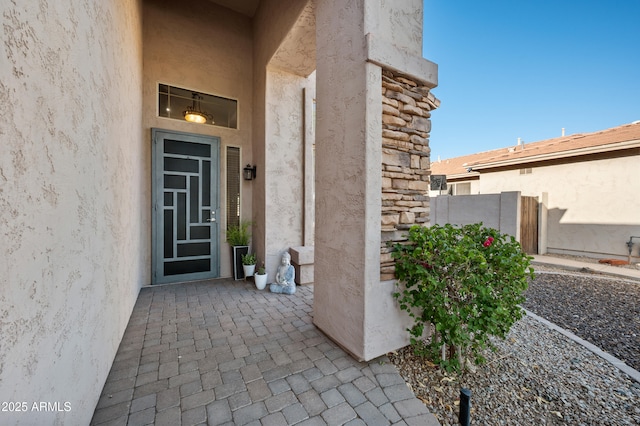 1834 W Nighthawk Way, Phoenix, AZ 85045 - property entrance with stucco siding, stone siding, and a patio area