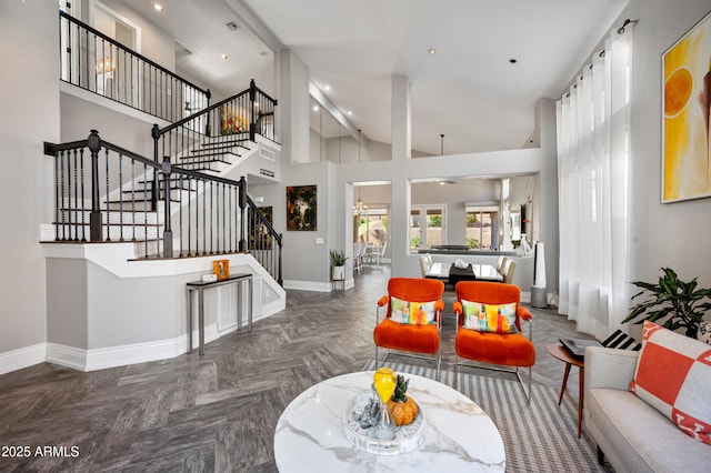 1834 W Nighthawk Way, Phoenix, AZ 85045 - living room with baseboards, stairs, high vaulted ceiling, a chandelier, and recessed lighting