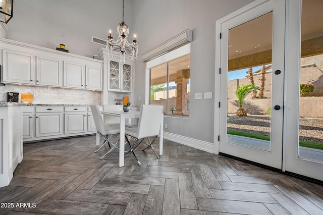 1834 W Nighthawk Way, Phoenix, AZ 85045 - dining area featuring a chandelier, baseboards, and a high ceiling