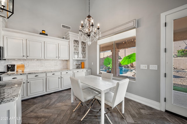 1834 W Nighthawk Way, Phoenix, AZ 85045 - dining space featuring a chandelier, baseboards, and a high ceiling
