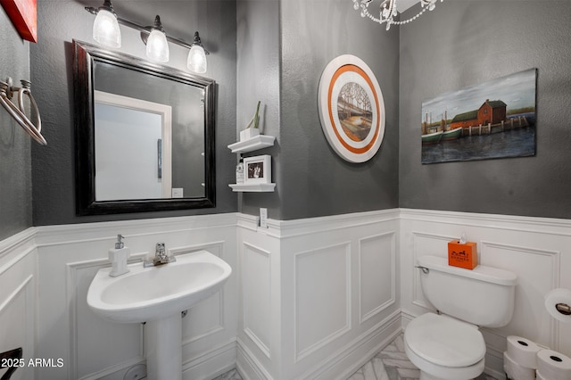 1834 W Nighthawk Way, Phoenix, AZ 85045 - bathroom featuring a wainscoted wall, a decorative wall, and toilet