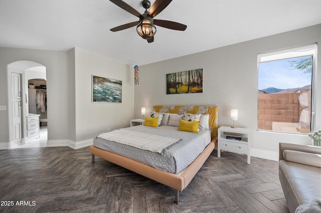 1834 W Nighthawk Way, Phoenix, AZ 85045 - bedroom with baseboards, arched walkways, and ceiling fan