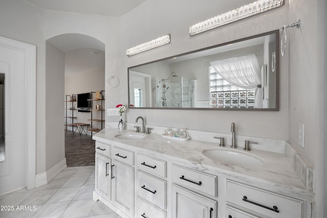 1834 W Nighthawk Way, Phoenix, AZ 85045 - bathroom with a stall shower, double vanity, and baseboards