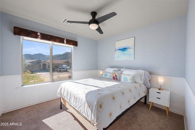 1834 W Nighthawk Way, Phoenix, AZ 85045 - bedroom with wainscoting, carpet flooring, a mountain view, and ceiling fan