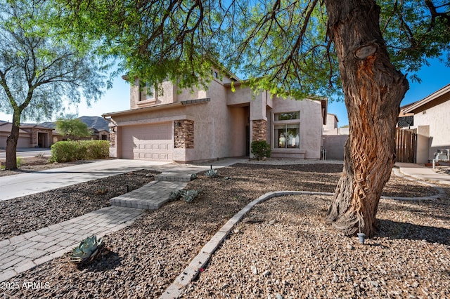 1834 W Nighthawk Way, Phoenix, AZ 85045 - view of front of home featuring stucco siding, a garage, driveway, and stone siding