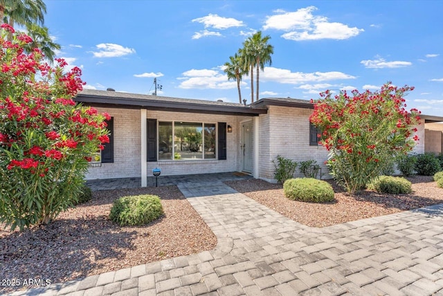 view of front of house featuring brick siding