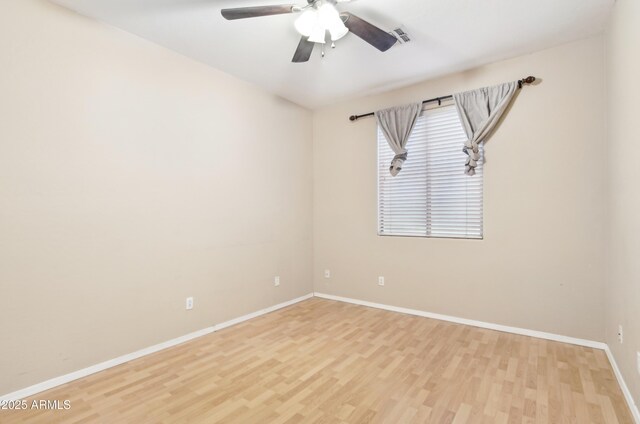 unfurnished room with light wood-style flooring, ceiling fan, baseboards, and visible vents