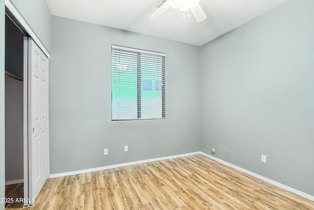 unfurnished bedroom with light wood-style floors, a closet, baseboards, and ceiling fan