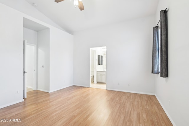 unfurnished room featuring light wood-type flooring, ceiling fan, baseboards, and vaulted ceiling