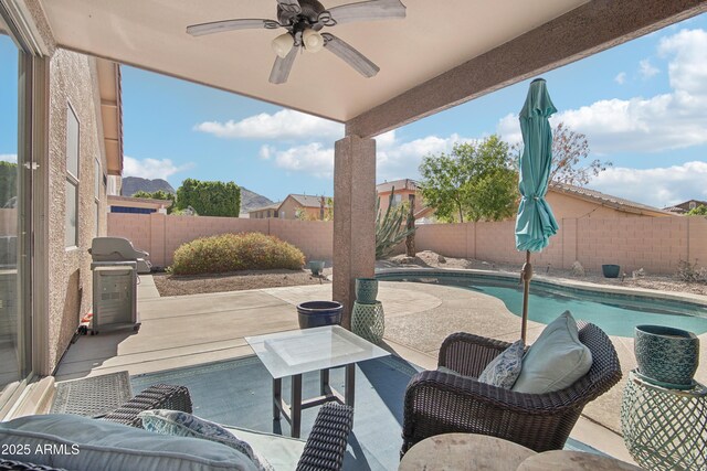 view of patio / terrace with grilling area, a fenced in pool, a fenced backyard, and ceiling fan