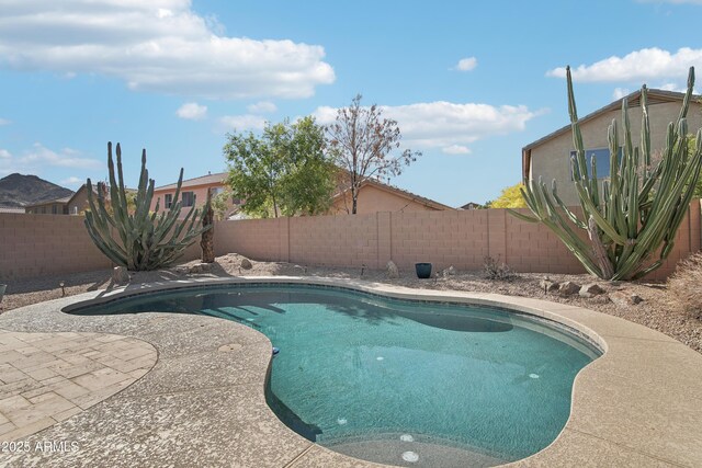 view of swimming pool featuring a fenced backyard, a fenced in pool, and a patio