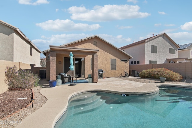 view of swimming pool featuring a fenced in pool, a patio area, a fenced backyard, and area for grilling