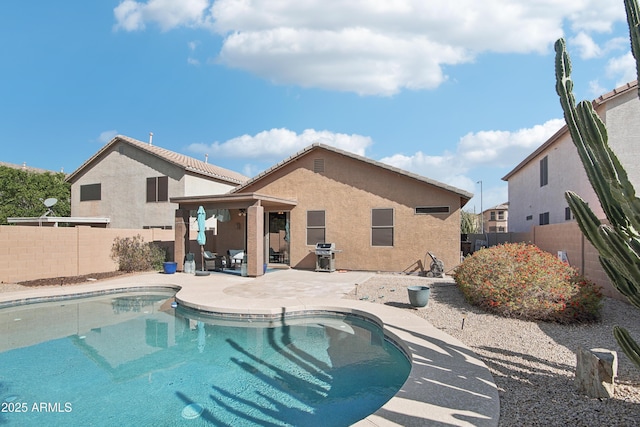 view of pool featuring a fenced in pool, a patio area, a fenced backyard, and area for grilling
