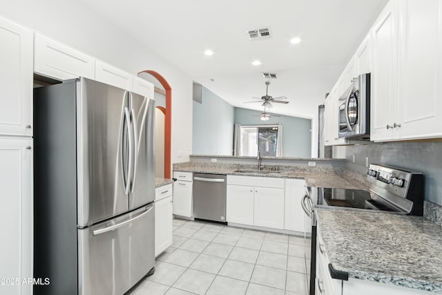 kitchen featuring visible vents, a sink, appliances with stainless steel finishes, a ceiling fan, and white cabinetry