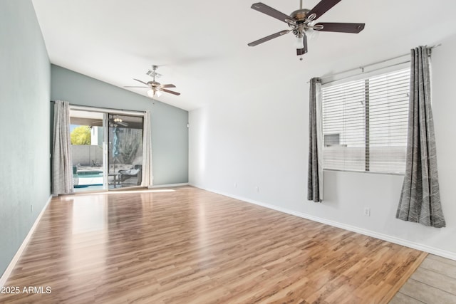 unfurnished living room featuring ceiling fan, baseboards, wood finished floors, and lofted ceiling