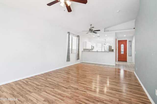 unfurnished living room with baseboards, ceiling fan, recessed lighting, light wood finished floors, and vaulted ceiling