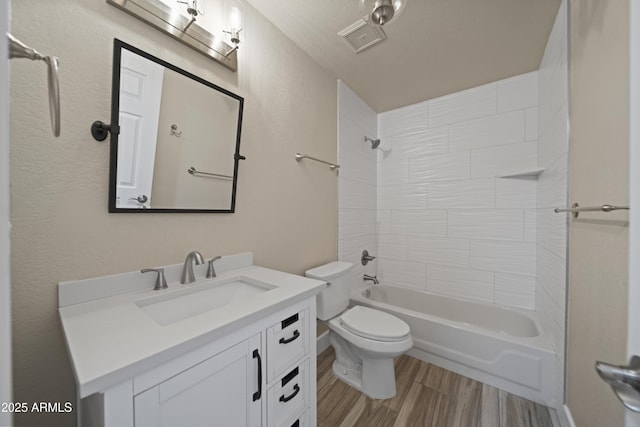 2105 W Terrace Dr, Wickenburg, AZ 85390 - bathroom featuring toilet, wood finished floors, bathtub / shower combination, visible vents, and vanity