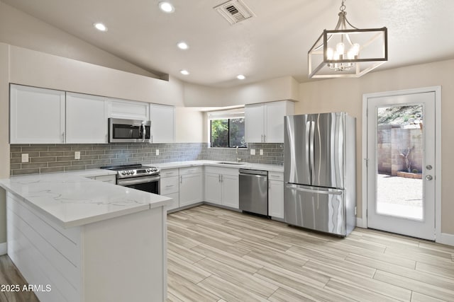 2105 W Terrace Dr, Wickenburg, AZ 85390 - kitchen featuring visible vents, a sink, backsplash, white cabinets, and appliances with stainless steel finishes