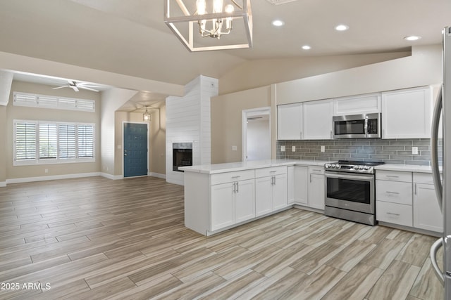 2105 W Terrace Dr, Wickenburg, AZ 85390 - kitchen with a peninsula, light countertops, appliances with stainless steel finishes, and open floor plan