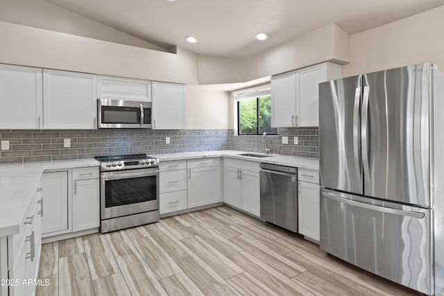 2105 W Terrace Dr, Wickenburg, AZ 85390 - kitchen featuring a sink, stainless steel appliances, tasteful backsplash, recessed lighting, and white cabinetry