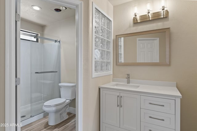 2105 W Terrace Dr, Wickenburg, AZ 85390 - full bathroom with toilet, vanity, wood finished floors, and a stall shower