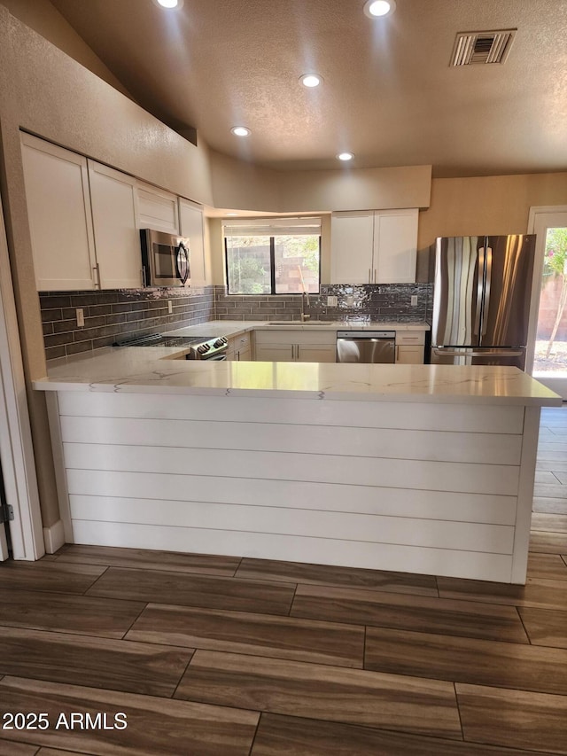 2105 W Terrace Dr, Wickenburg, AZ 85390 - kitchen featuring decorative backsplash, a textured ceiling, visible vents, stainless steel appliances, and recessed lighting