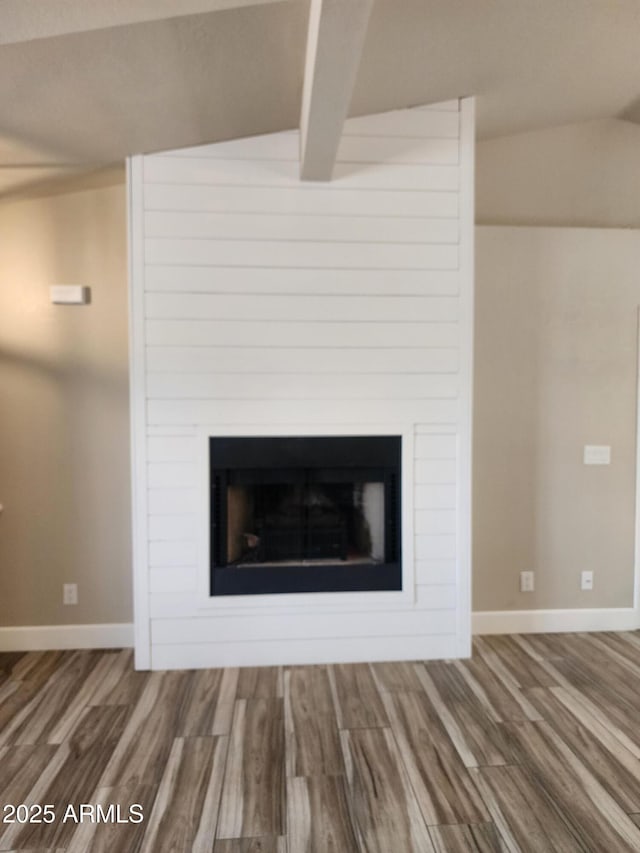 2105 W Terrace Dr, Wickenburg, AZ 85390 - details featuring baseboards, a large fireplace, wood finished floors, and beam ceiling