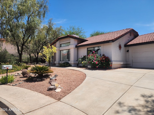 2105 W Terrace Dr, Wickenburg, AZ 85390 - mediterranean / spanish house featuring stucco siding, a garage, a tiled roof, and driveway