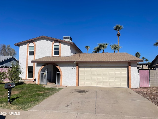 view of front of property with a garage and a front yard