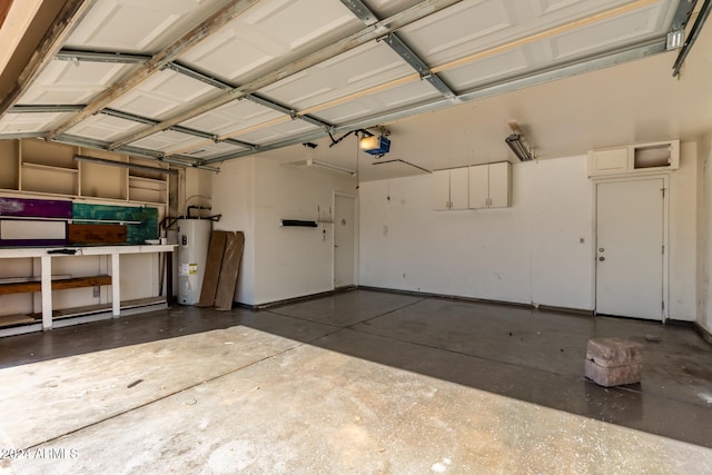 garage featuring a garage door opener and electric water heater