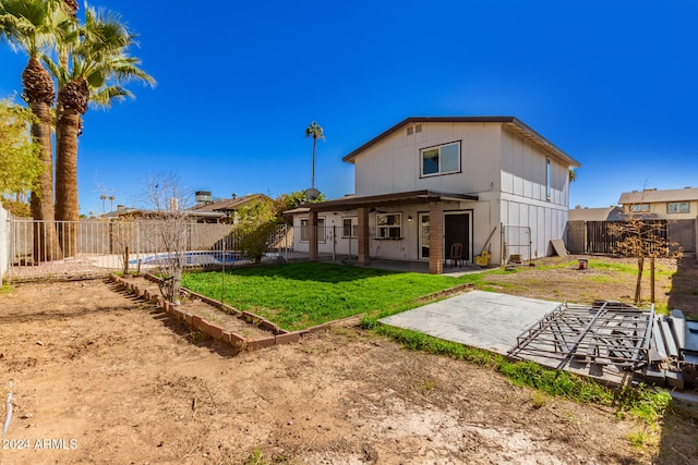 back of property featuring a patio and a lawn