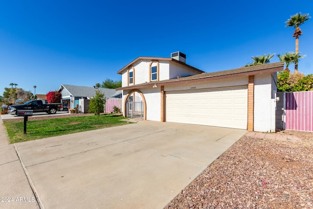 view of front of property with a garage and a front lawn