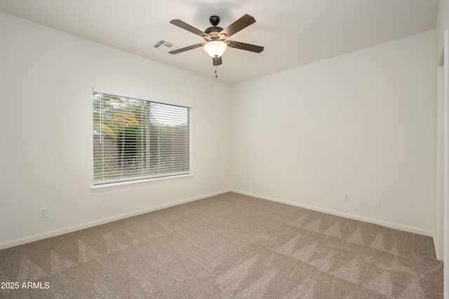 empty room with a ceiling fan, baseboards, visible vents, and carpet flooring