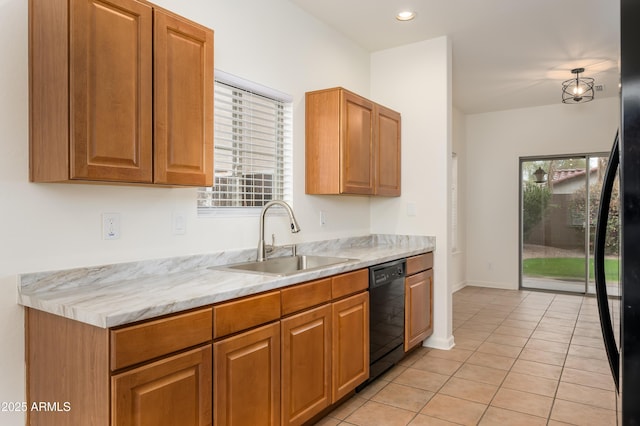 kitchen with light tile patterned floors, black appliances, a sink, and a wealth of natural light