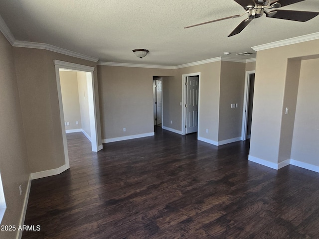 spare room with dark wood-style floors, crown molding, a textured ceiling, and baseboards