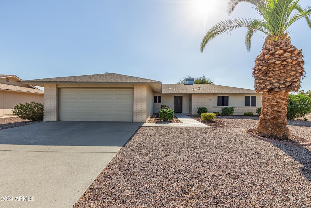 ranch-style home featuring a garage