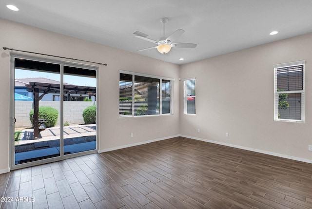 empty room featuring hardwood / wood-style floors, a wealth of natural light, and ceiling fan