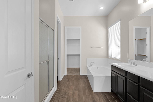 bathroom with vanity, shower with separate bathtub, a healthy amount of sunlight, and hardwood / wood-style floors