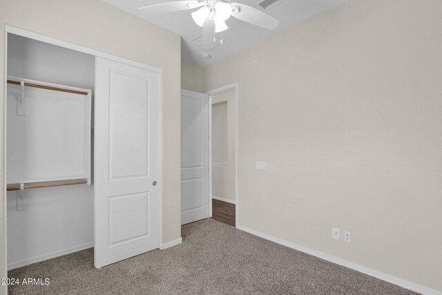 unfurnished bedroom featuring a closet, ceiling fan, and light colored carpet