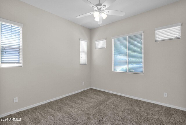 unfurnished room with carpet and ceiling fan