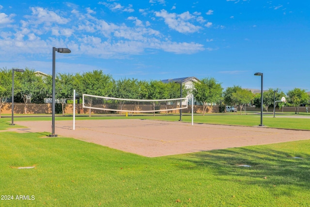 surrounding community featuring a lawn and volleyball court