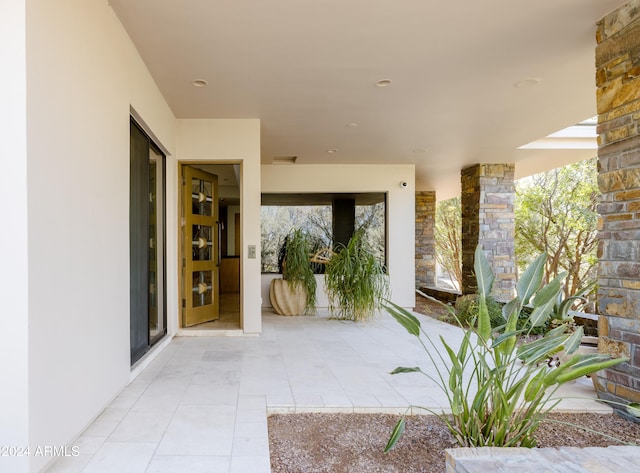 entrance to property featuring a patio