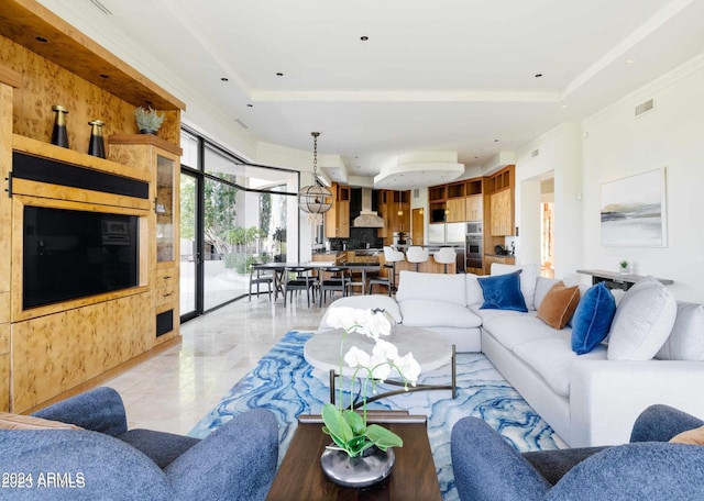 living room with a raised ceiling and crown molding