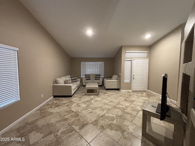 unfurnished living room with baseboards